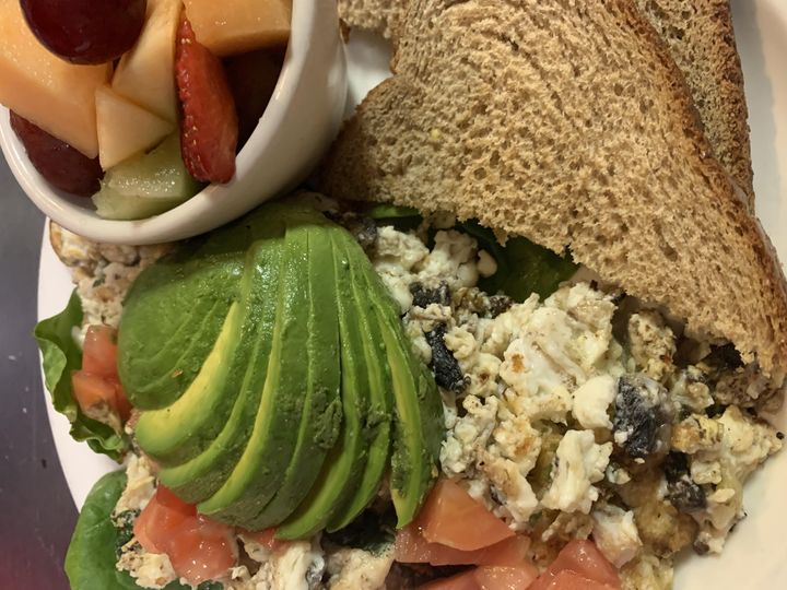 Egg white scramble with avocado, a fruit cup and wheat toast