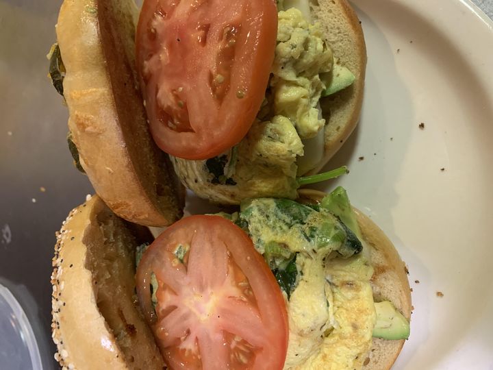 Open-faced veggie breakfast bagel with egg, tomato, spinach and avocado